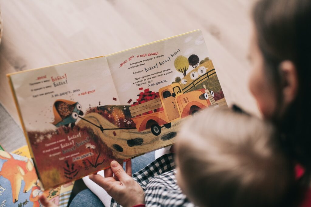 Mum reading a book to her child